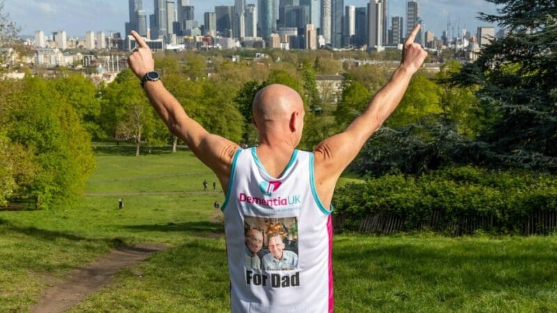 Participant in the London Marathon wearing a Dementia UK t-shirt with a picture of their dad.