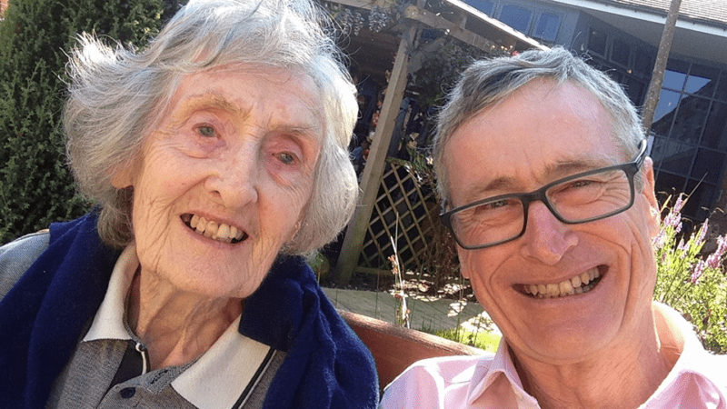 Richard and mum Peggy beam at the camera on a sunny day