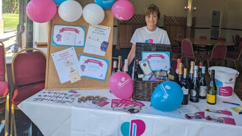 supporter raising funds for Dementia UK at a stall